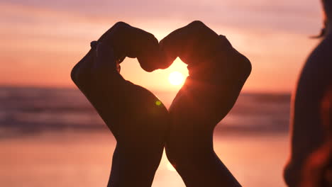 Love,-heart-and-hands-of-woman-at-beach