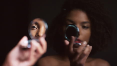 Black-woman,-makeup-and-round-mirror-in-hands
