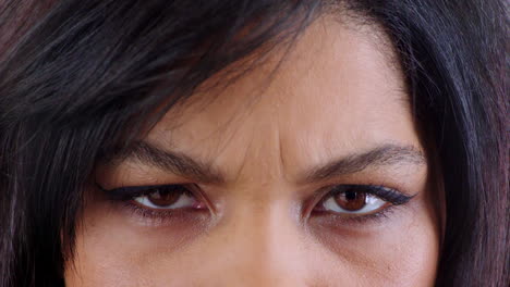 Woman,-face-or-angry-brown-eyes-in-stress