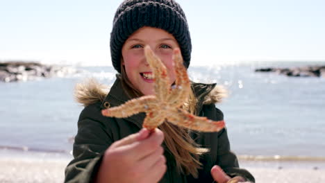 Child-face,-girl-and-starfish-by-beach