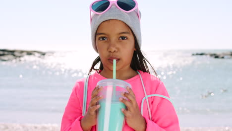 Girl,-beach-and-drink-milkshake