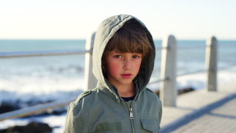 Sad,-cold-and-face-of-a-child-at-the-beach