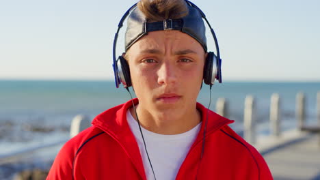 Teen-with-headphones,-beach-and-travel-with-music