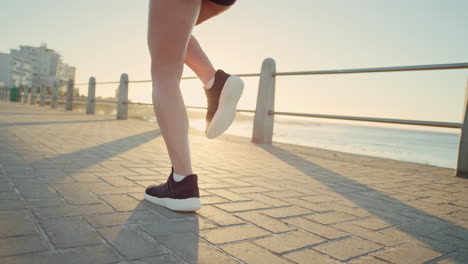 Running-shoes,-legs-and-body-of-woman-at-beach