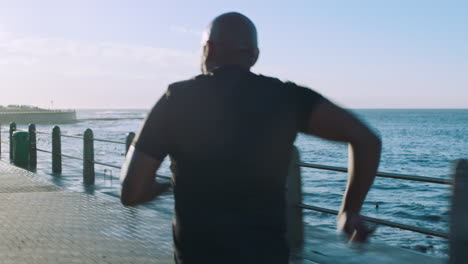 Fitness,-motivation-and-black-man-running-by-ocean
