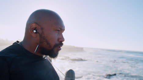 Beach,-fitness-and-music-of-black-man-with-peace