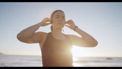 Fitness,-tired-and-woman-at-beach-with-music