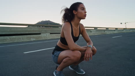 Black-woman,-fitness-rest-and-runner-on-city-road