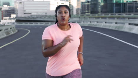 Fitness,-city-and-black-woman-running-on-road