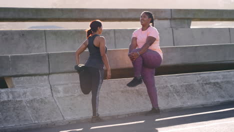Fitness,-friends-and-women-stretching-in-city