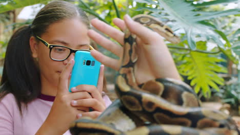 Phone,-nature-and-girl-with-snake-in-hands