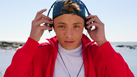 Man,-music-headphones-and-face-at-beach-for-summer