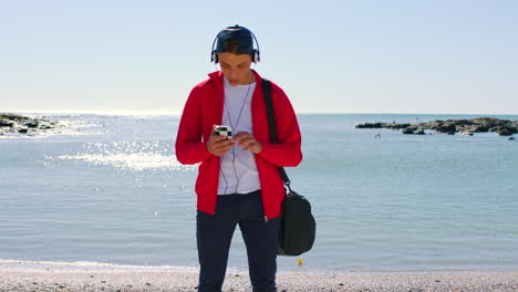 Headphones,-phone-and-teenager-at-the-beach