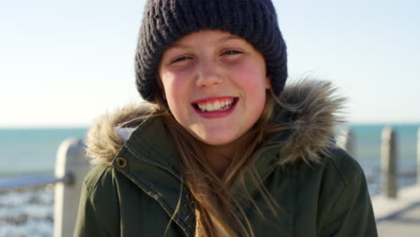 Ocean,-happy-and-face-of-child-on-winter-vacation