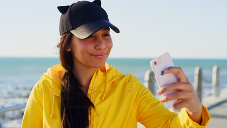 Phone-selfie,-beach-and-woman-on-holiday-in-summer