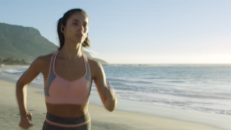 Beach,-running-and-woman-by-the-ocean-for-fitness