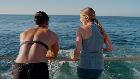 Ocean,-fitness-and-talking-couple-relax