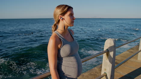 Music,-beach-and-pregnant-woman-listening-to