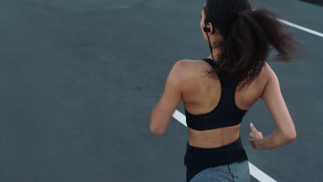Back-view,-fitness-or-black-woman-running-on-road