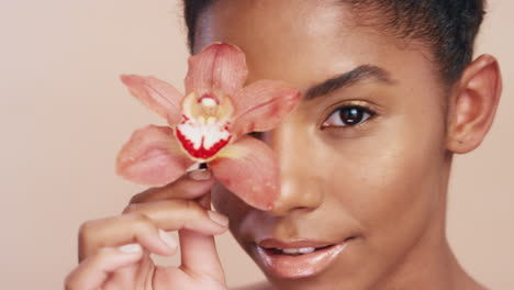 Woman,-face-and-flower-with-smile-for-skincare