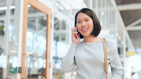 Asian-business-woman-on-a-phone-call-walking