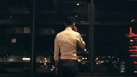 Business-man,-phone-call-and-window-at-night