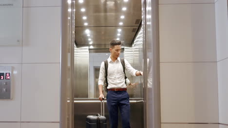 Travel,-hotel-elevator-and-man-with-suitcase