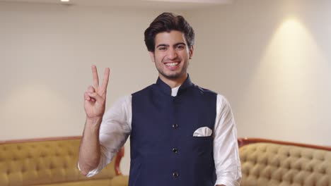 Indian-politician-showing-victory-sign-to-the-camera