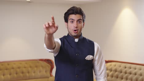 Indian-man-saying-hello-and-waving-hands