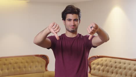 Upset-Indian-man-showing-thumbs-down