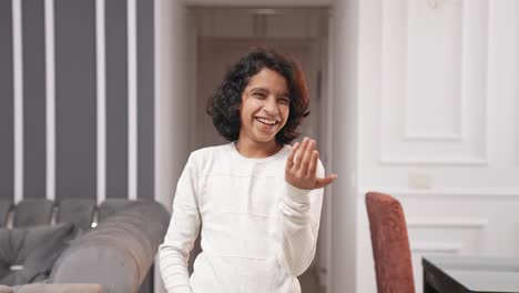 Playful-Indian-kid-boy-making-fun-of-someone-and-laughing