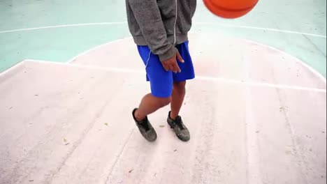 Top-view-of-unrecognizable-african-american-man-practicing-basketball-outside.-Slow-Motion-shot