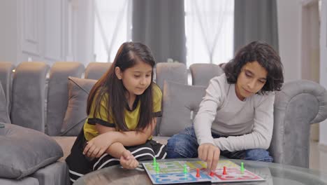 Indian-siblings-playing-Ludo-board-game