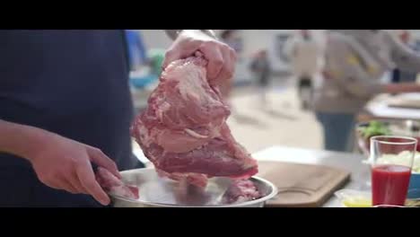 Person's-hands-preparing-a-large-piece-of-raw-meat-for-cooking.-The-wooden-surface-outside.-Barbeque-time.-shot-in-4k