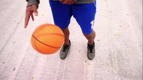 Close-Up-view-of-unrecognizable-african-american-man-practicing-basketball-outside.-View-from-the-top.-Slow-Motion-shot