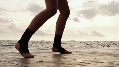Female-boxer's-legs-moving-on-during-the-training.-Woman-is-training-by-the-beach.-Close-Up-on-legs.-Slow-Motion-shot