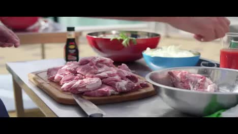Person's-hands-preparing-raw-meat-for-cooking.-The-wooden-surface-outside.-Barbeque-time.-shot-in-4k
