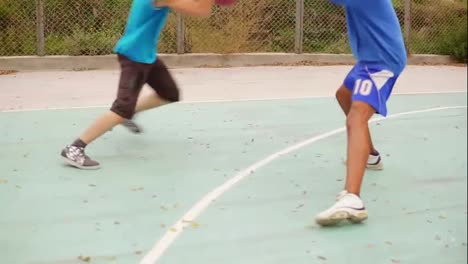 Two-young-friends-play-basketball-on-the-street.-One-guy-gets-a-ball-in-the-basket.-Slow-Motion-shot