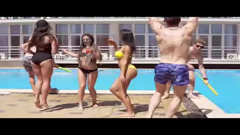 Happy-young-cheerful-friends-dancing-and-having-fun-at-the-pool.-Summertime-pool-party.-Slow-Motion-shot
