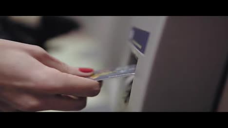 Frauenhand-Mit-Lackierten-Roten-Nägeln,-Die-Eine-Kreditkarte-In-Den-Geldautomaten-Einführt.-Schöne-Maniküre