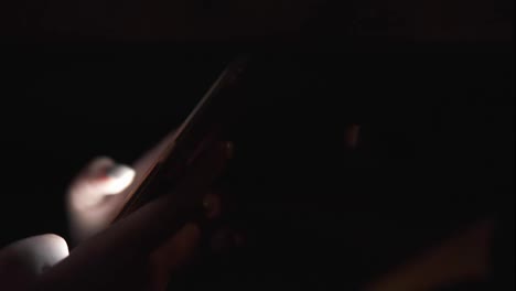 Close-Up-view-of-woman's-hands-texting-using-her-smartphone.-Woman-riding-in-taxi-late-at-night.-Night-live.-Slow-Motion-shot