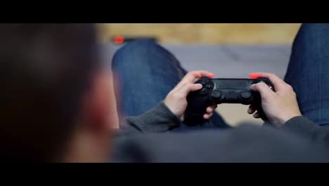 Close-Up-view-of-man's-hands-playing-video-game-at-home.-Shooting-and-controlling-using-the-game-controller.-Wireless-game