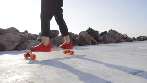 Man-in-red-sneakers-skates-in-park