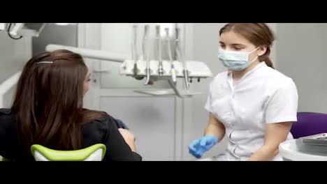 Young-female-patient-at-dentist-consultation-in-orthodontic-clinic.-Listening-to-the-doctor's-advices-after-the-inspection