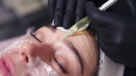 Doctor-makes-multiple-injections-in-woman's-face-skin-during-mesotherapy.-Biorevitalization-and-face-lifting,-non-surgical