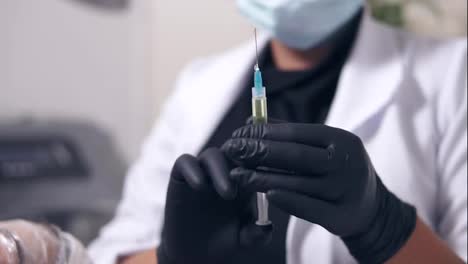 Professional-doctor-in-gloves-and-mask-with-medical-syringe-in-hands,-getting-ready-for-injection.-Close-Up-view