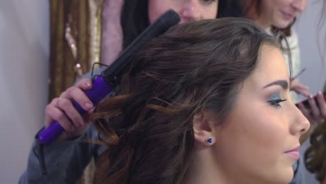 Beautiful-woman-having-her-hair-curled-in-barber-salon