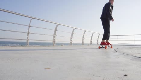Young-man-in-red-sneakers-skating-by-the-sea