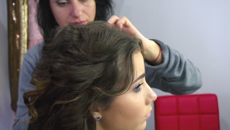 Beautiful-woman-having-her-hair-curled-in-barber-salon