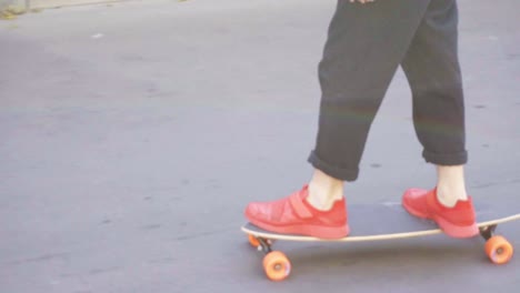 Young-man-in-red-sneakers-skating-in-the-street